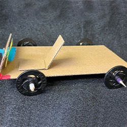 Gravity powered car made out of cardboard and other recycled materials.